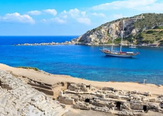 blue sea with a gulet ship, ampitheater of Knidos